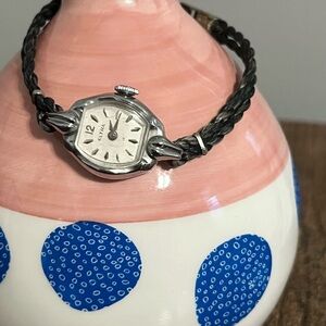 Vintage Eltra wind up watch with original chord wrist band